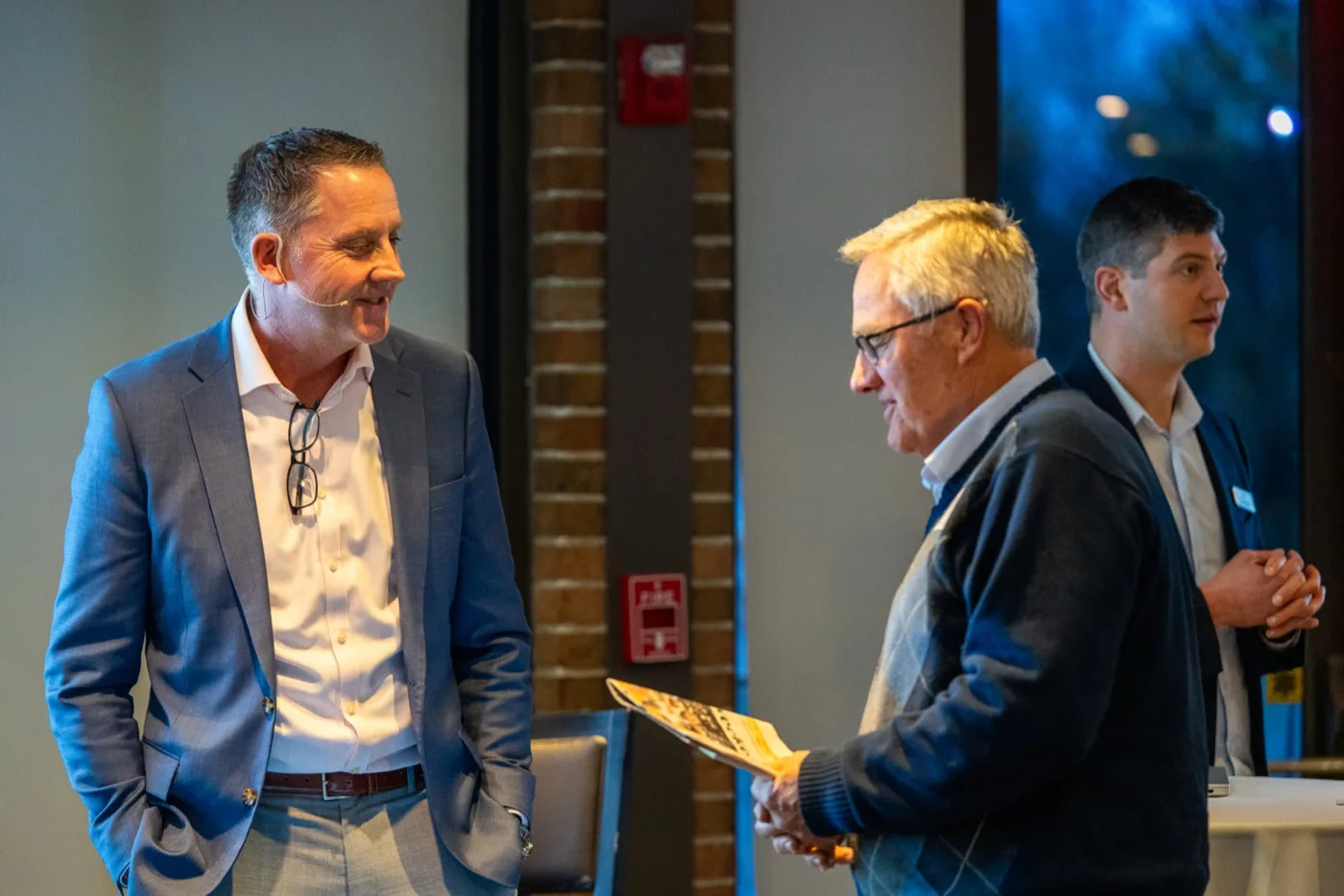 Advisors talking with guests at an Investor Coaching Series event